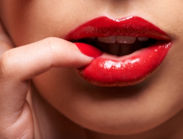 Cropped shot of a woman pressing her finger against her lip